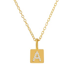 May include: A gold chain necklace with a square pendant featuring the letter "A" set with small clear stones.