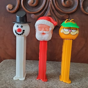 3 Vintage PEZ Candy Dispensers - Santa Claus, Garfield the Cat, Snowman - old toys