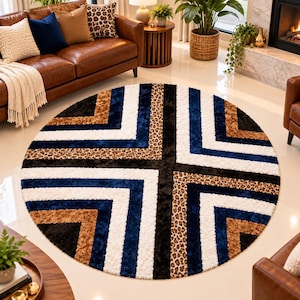 May include: A round area rug featuring a geometric pattern of alternating stripes in navy blue, white, black, and brown, accented with sections of leopard print. The rug has a plush, textured pile and is arranged in a symmetrical, radial design.