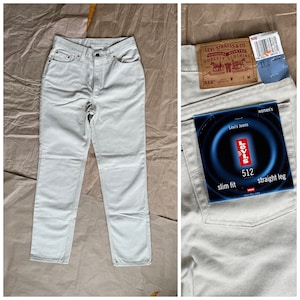 May include: A pair of light-wash denim jeans with a slim fit and straight leg. The jeans have a Levi's label with the text "Levi's Jeans", "512", "slim fit", and "straight leg".