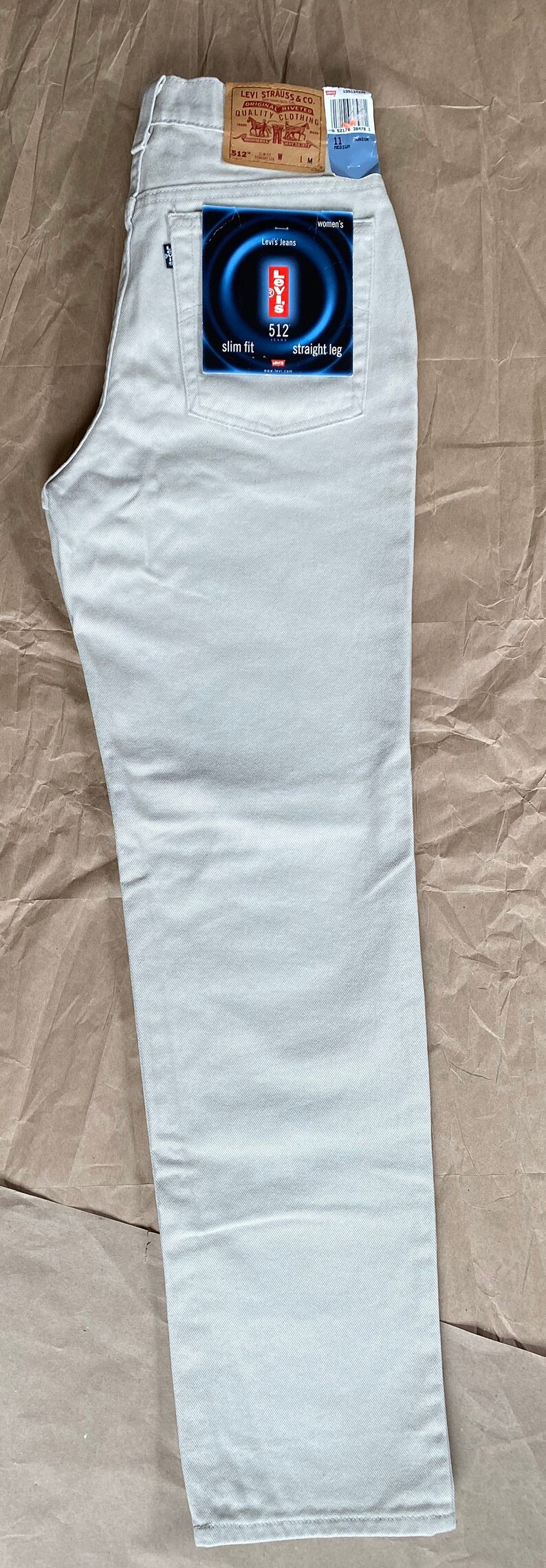 May include: A pair of light-colored jeans with a Levi's tag that says "slim fit 512 straight leg".