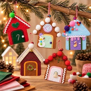 May include: Five felt house ornaments hanging from a branch. The houses feature various colors including red, brown, blue, and maroon, decorated with pom-poms, lace, and stitched details. Each ornament has a red and white striped string for hanging.