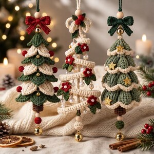 May include: Three hanging crochet ornaments shaped like Christmas trees. The left tree has green and cream layers with red berries. The center tree is a cream spiral with red flowers and pearls. The right tree is green with gold stars.