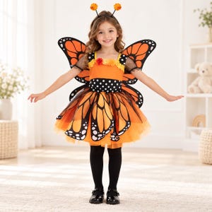 May include: A butterfly costume featuring a vibrant orange and black wing-patterned dress with a polka-dot bodice, sheer black sleeves, and a layered tulle skirt. The outfit includes a matching headband with two orange pom-pom antennae.