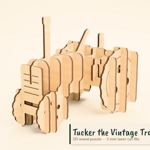 May include: A 3D wood puzzle of a tractor, labeled Tucker the Vintage Tractor, 3D wood puzzle, 3 mm laser cut file. The puzzle is constructed from light-colored wood pieces with a visible grain, featuring a front grille, wheels, and a vertical exhaust pipe.