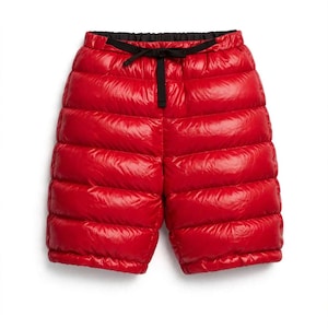May include: Bright red quilted shorts featuring a shiny, puffer-style finish with horizontal stitching. The shorts have a black elastic waistband with an integrated black drawstring tie at the centre front for an adjustable fit.