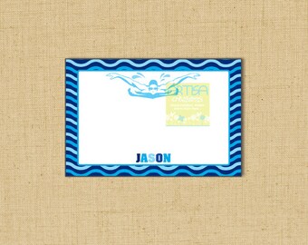May include: A rectangular card with a blue wave pattern border. The card features a swimmer graphic and the name "JASON" in blue. The card also includes the text "ARTISA creations" and a floral design.