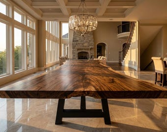 May include: A large dining table featuring a thick, natural-edge wooden slab top with prominent brown grain patterns, supported by a sturdy black metal trestle base, positioned in a spacious room with large windows and a stone fireplace.
