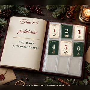 May include: An open album with a cream-colored page featuring the text True 3x4 pocket size FITS STANDARD DECEMBER DAILY ALBUMS. The opposite side contains clear plastic sleeves holding six rectangular cards numbered 1 through 6.