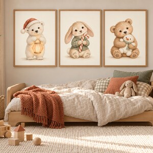May include: Three framed wall art prints featuring a white bear in a red hat holding a lantern, a rabbit in a green sweater holding a candy cane, and a brown bear holding a small snowman, displayed above a wooden bed with a textured blanket.
