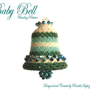 May include: A white and green beaded bell ornament with a crystal-like finish. The bell is decorated with a white and green striped pattern and has a loop at the top for hanging. The text "Baby Bell Beading Pattern" is written above the bell.