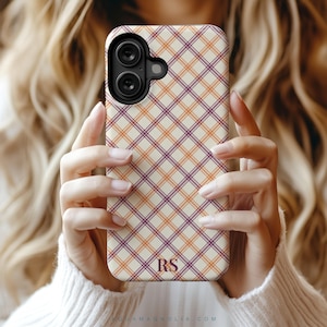 image of a iPhone case from a collection of 9 patterns to choose from; plaid, gingham tartan and checkered in warm colors olive, cream, plum, burgundy and harvest tones, personalized with a delicate name, monogram or initials. Available for the 17, 16, 15, 14, 13, 12 iPhone models. Clear, slim, tough and MagSafe case styles.