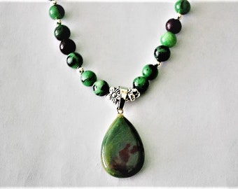 Ruby Zoisite Beaded Necklace with Silver Flower Spacers/Round Silver Spacers and an Ruby Zoisite Gemstone Pendant.  18 in.