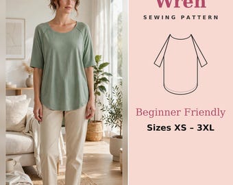 May include: A sewing pattern titled Wren featuring a line drawing of a short-sleeved shirt with a rounded hem. The text includes Sewing Pattern, Beginner Friendly, and Sizes XS - 3XL. The design is presented on a light pink background.