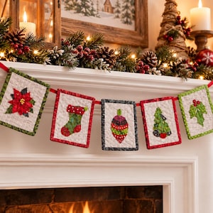 May include: A fabric holiday garland featuring five rectangular quilted panels suspended on a red ribbon. Each panel displays a different Christmas-themed appliqué, including a red poinsettia, a green stocking, a colorful ornament, a tree, and holly.