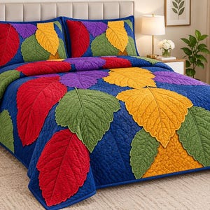 May include: A blue quilt and two matching pillow shams featuring a vibrant appliqué pattern of large, textured leaves in shades of red, green, yellow, and purple. The fabric has a quilted texture throughout the entire bedding set.