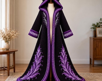 May include: A long, black hooded cloak featuring a textured knit pattern, purple trim, and large purple leaf-like embroidery along the front panels and cuffs. The hood includes two prominent, curved, horn-like structures at the top.
