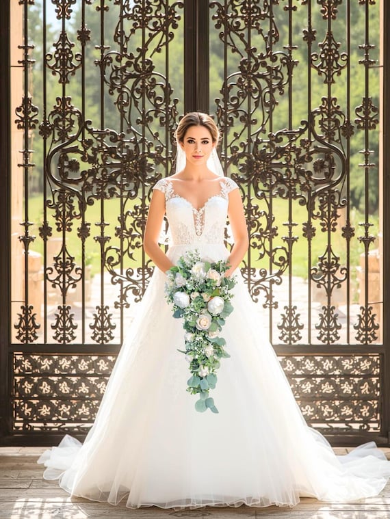 white bouquet with ivory dress Terri's bridal bouquet a soft study in tenderness and romance. Blush and caramel-toned garden roses unfold gently among clouds of ivory orchids and delicate white blooms, each stem chosen for its quiet