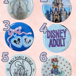 May include: Six circular pin-back buttons featuring Disney-themed designs. Button 1 shows a castle illustration with a blue bow. Button 2 depicts a castle photograph. Button 3 shows Mickey and Minnie in heart frames. Button 4 says DISNEY ADULT. Button 5 shows a Walt Disney World Magic Kingdom 1971 logo. Button 6 features Daisy Duck on a pink polka dot background.