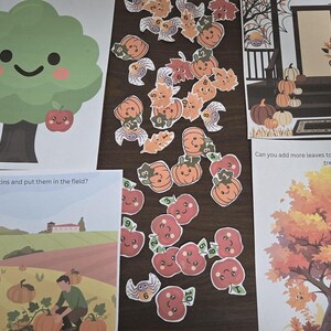 May include: A collection of educational activity sheets and cut-out pieces featuring autumn themes. The set includes a smiling tree, a pumpkin field scene with the text 'Can you find more pumpkins and put them in the field?', a porch scene, and a tree with the text 'Can you add more leaves to the leaves falling from the tree?', alongside various small cut-out apples, pumpkins, and leaves.