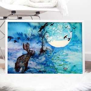 May include: A watercolour painting of a rabbit running through a misty forest under a full moon. The sky is blue and there are birds flying in the air. The painting is framed in a white frame.