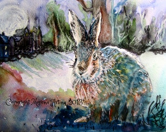 May include: A watercolor painting of a blue-grey rabbit in a snowy landscape. The rabbit is facing the viewer with its ears perked up. The background is a soft blue and purple with a few trees and a small village in the distance. The painting is signed "Copyright Morena Artina 2013".