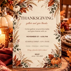 May include: A rectangular Thanksgiving invitation card featuring a cream background with autumn-themed illustrations of pumpkins, dried grasses, and fall leaves. The text reads: THANKSGIVING, gather and give thanks, Come gather around the table and give thanks with us, NOVEMBER 27, 4:00 PM, 123 MAPLE STREET, CITY, STATE, FOOD, FRIENDS, GRATITUDE, Bring a favourite dish to share!, RSVP, Jane, 123-4567.