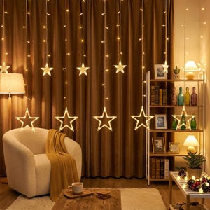 May include: A string light curtain featuring vertical strands with warm white LED lights and hanging star-shaped ornaments. The lights are arranged in a cascading pattern against a brown curtain backdrop, creating a glowing display of stars.