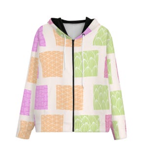 May include: A zip-up hoodie featuring a cream-coloured base with a repeating pattern of rectangular blocks in shades of light orange, lime green, and magenta. The blocks contain various geometric line designs, and the hoodie has a black inner lining.