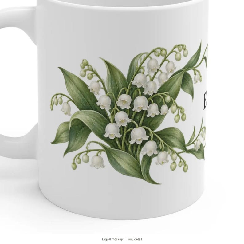 May include: A white ceramic mug featuring a detailed botanical illustration of lily of the valley flowers with green leaves and small white bell-shaped blossoms. The design is centered on the side of the mug, showcasing a cluster of stems.
