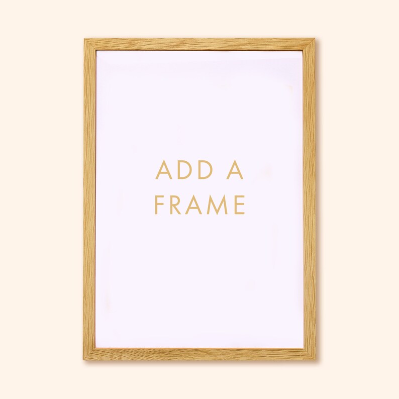 May include: A rectangular wooden picture frame with a light wood grain finish. The white interior has the words "ADD A FRAME" in gold lettering. The frame is designed to hold a picture or artwork.
