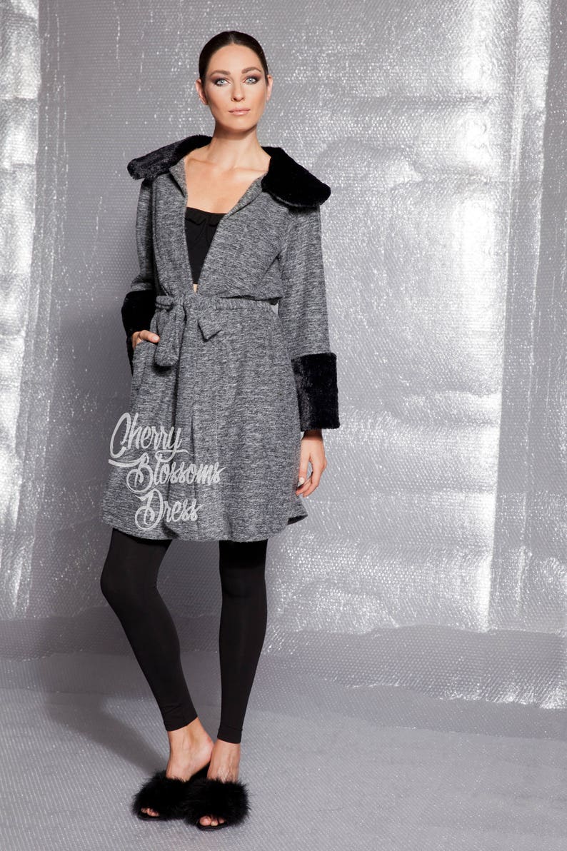 Soft grey cardigan with faux fur collar and faux fur cuffs. Our cardigan has belt for a fitted look. The fabric is so soft and warm. The perfect fall clothing.