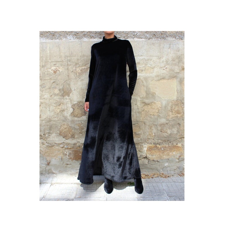 May include: A long black velvet dress with a mock neck and long sleeves.