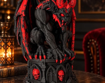 May include: A black and red gargoyle figurine featuring large wings, sharp horns, and glowing red eyes. The creature is perched on a circular pedestal decorated with arched gothic-style alcoves containing small red skull carvings at the base.