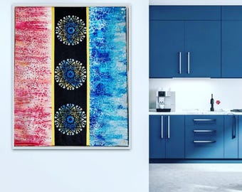 May include: A rectangular canvas painting featuring three vertical sections. The left side has a pink and white mottled texture, the center is a black stripe with three blue and gold mandala designs, and the right side is blue and white.