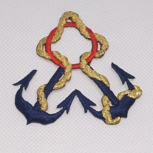 May include: A gold and blue embroidered anchor with a red and gold rope design. The anchor is a nautical symbol of hope and strength.