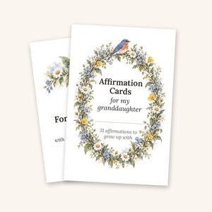 May include: A set of affirmation cards for my granddaughter featuring a floral wreath illustration with a bluebird, yellow and white flowers, and green leaves. The text reads: Affirmation Cards for my granddaughter, 31 affirmations to grow up with.