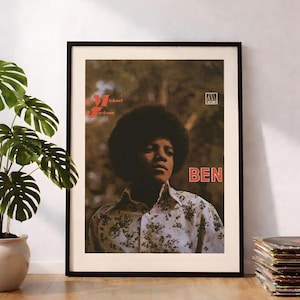 May include: A framed poster featuring a portrait of a young Michael Jackson with an afro hairstyle, wearing a floral print shirt. The text "Michael Jackson" appears in red, and the word "BEN" is printed in large red letters on the right side.