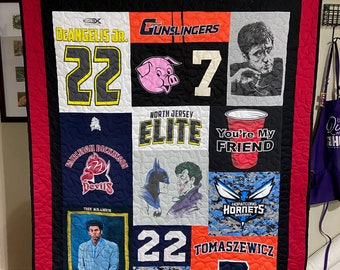 May include: A red, black and white quilt with various patches of fabric. The patches include a pig, a Batman and Joker graphic, a red cup with the text "You're My Friend", a baseball jersey with the text "Hopatcong Hornets", and a jersey with the text "Tomaszewicz 7".