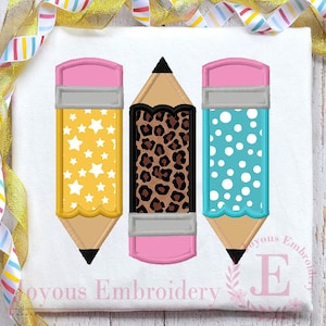 May include: Three embroidered pencils with different patterns. The pencils are yellow, brown, and blue with pink erasers. The patterns are stars, leopard print, and polka dots.