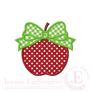 May include: An embroidered apple design featuring a red base with white polka dots and a green and white gingham patterned bow tied at the top. A brown stem extends from the center of the apple, and the text Joyous Embroidery is visible.
