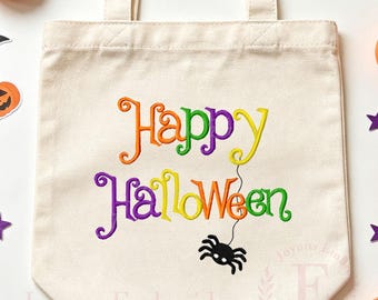 May include: A natural-colored canvas tote bag featuring embroidered text that reads Happy Halloween in vibrant orange, green, purple, and yellow letters. A small black spider hangs from the letter n by a thin black thread.