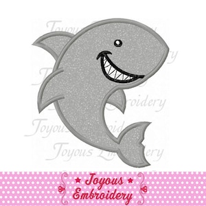 May include: A smiling cartoon shark in grey with a textured pattern. The shark has a black outline, a white-toothed grin, and a small black eye. The image includes the text "Joyous Embroidery" in red.