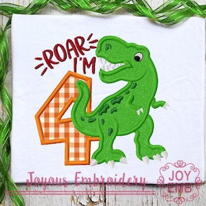 May include: Embroidered design of a green dinosaur with a number four in orange and white checkered pattern. The text "Roar I'm" is above the dinosaur.