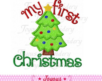 May include: A green Christmas tree with red, blue, and yellow ornaments and a gold star on top. The words "my first Christmas" are embroidered in red and green. The image is on a white background.