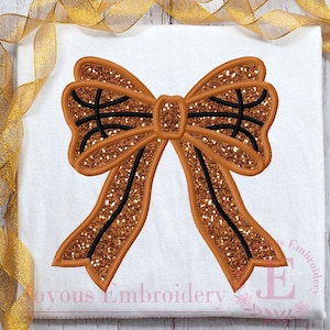 May include: A large, brown glitter bow with black outlines. The bow is on a white background.