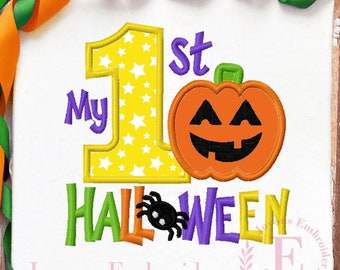 May include: White fabric with the text "My 1st Halloween" in purple, green, orange, and yellow. A yellow number 1 is filled with white stars. An orange jack-o'-lantern and a black spider are also featured.