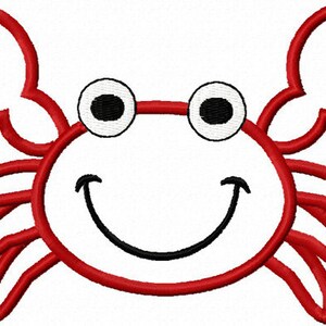 May include: A red embroidered crab design with a smiling face and large, expressive eyes. The crab has two large claws and is outlined in red thread. The design is on a white background, creating a cheerful and playful image.