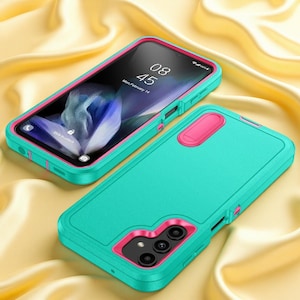 May include: A smartphone encased in a dual-layer protective cover featuring a vibrant teal and hot pink color scheme. The case includes a built-in kickstand on the back and a camera cutout. The screen displays the time 08:45 and date.