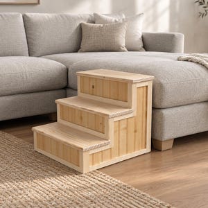 May include: A three-step wooden pet staircase constructed from light-colored natural wood planks. The structure features a vertical panel design on the sides and horizontal treads for each step, providing a stable platform for climbing.